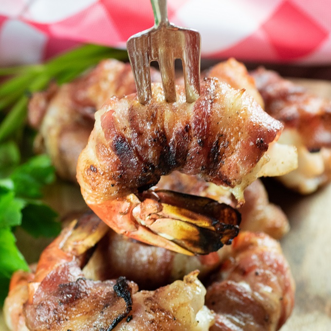 Grilled bacon wrapped shrimp on a silver fork