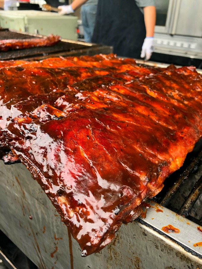 Smoked ribs all covered in sauce on the grill