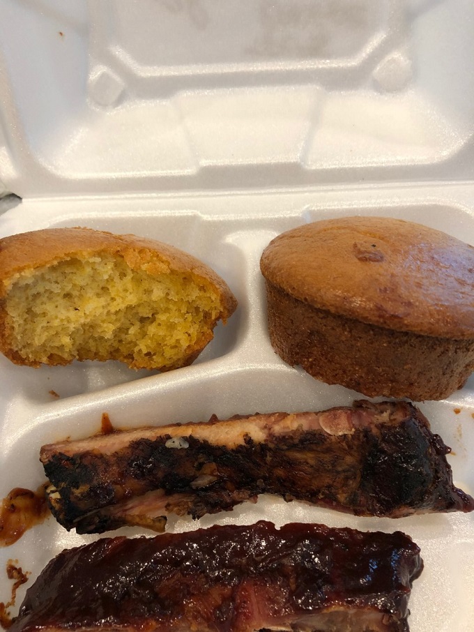  Corn muffins and smoked ribs in a take-out container