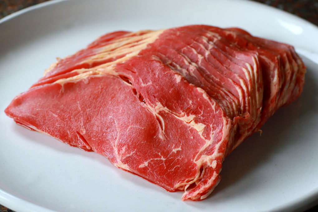 Thinly sliced sirloin steak. 