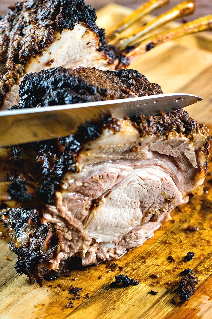 Slicing the BBQ pork roast on a wooden cutting board
