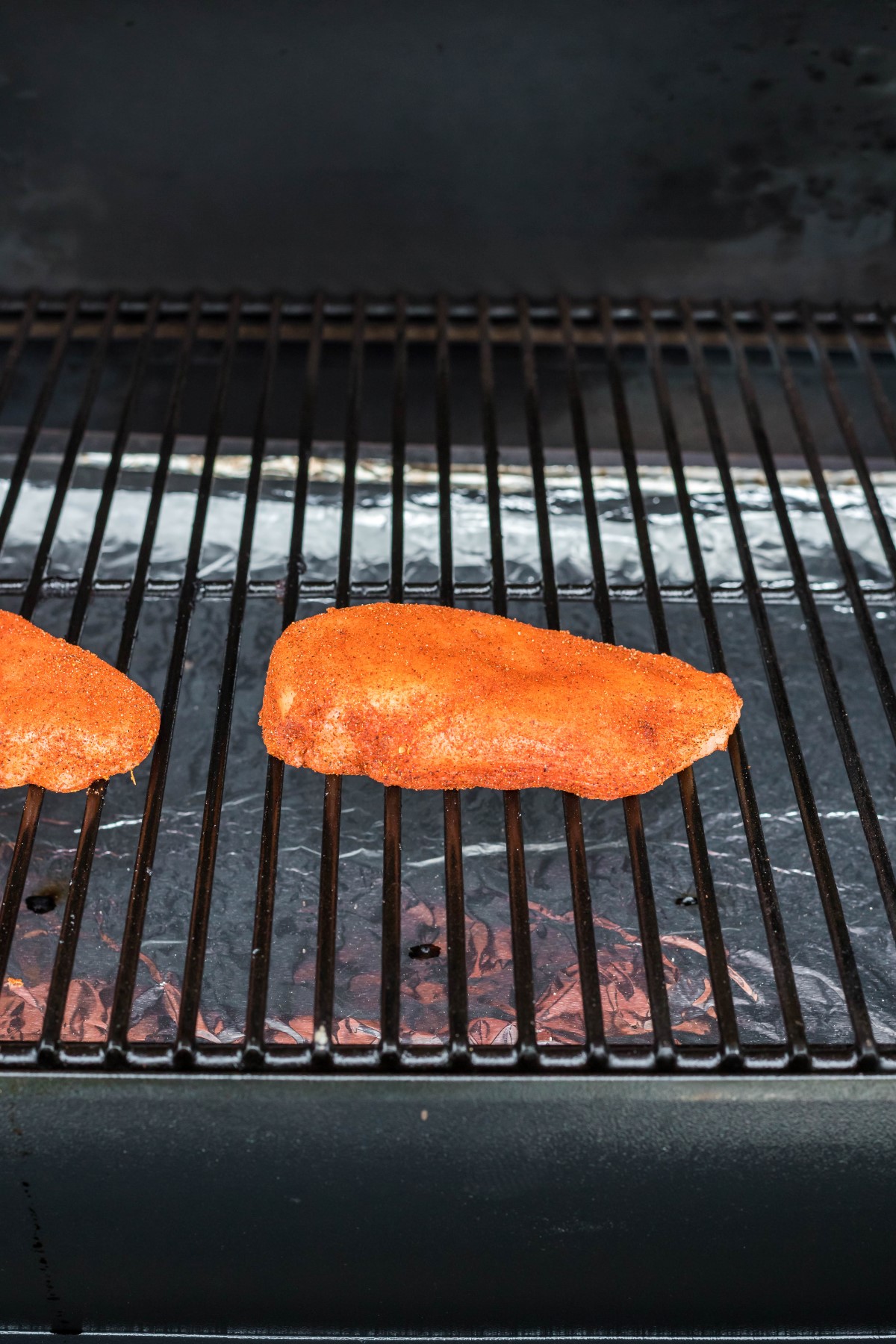 bbq rub chicken breasts on a bbq grill