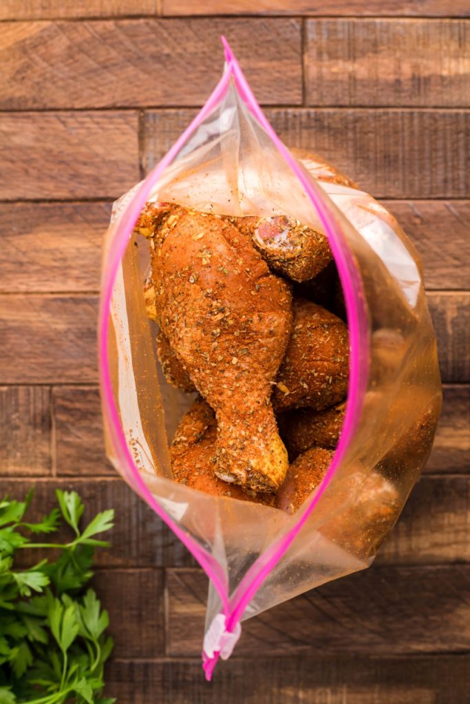 Drumsticks covered in dry rub in a plastic sealable bag