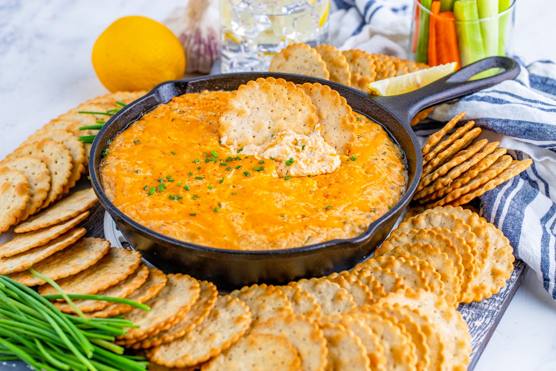 Cast iron skillet with smoked crab dip served with crackers.