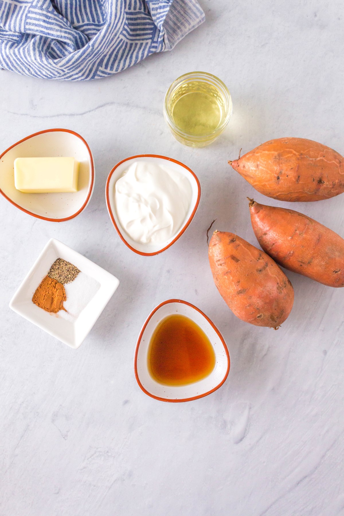 Ingredients for grilled mashed sweet potatoes in small bowls on a marble counter top.