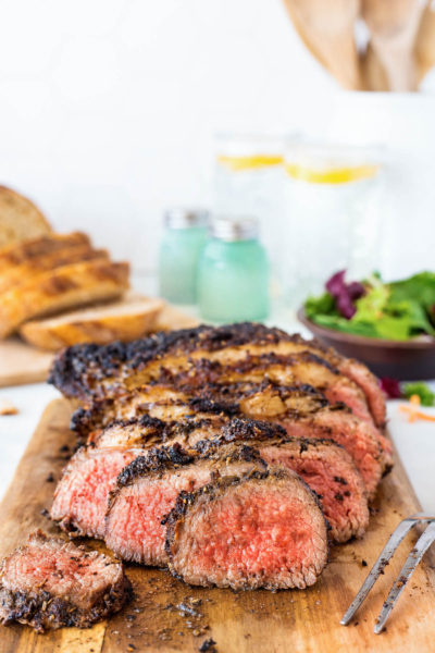 Grilled Tri Tip steak sliced on a wooden cutting board