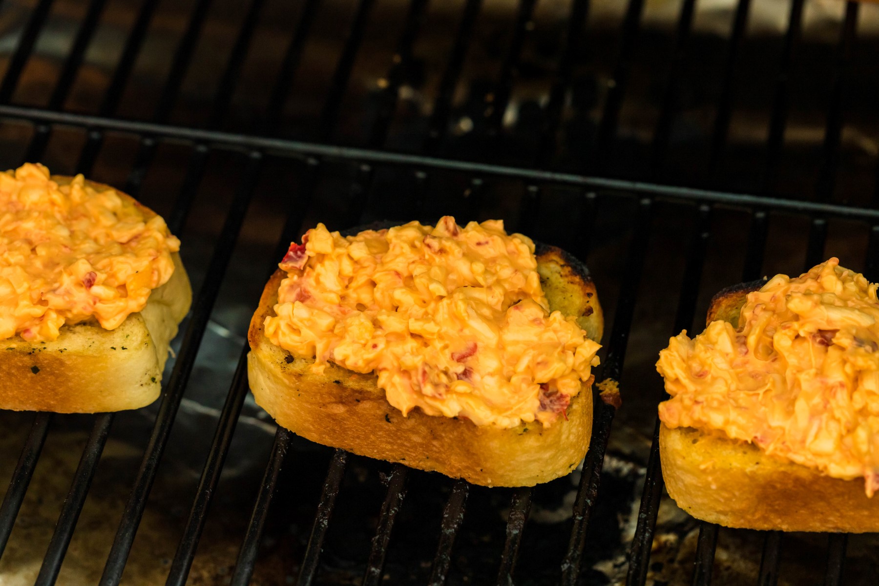 Pimento cheese spread over the Texas toast as it cooks on the grill.