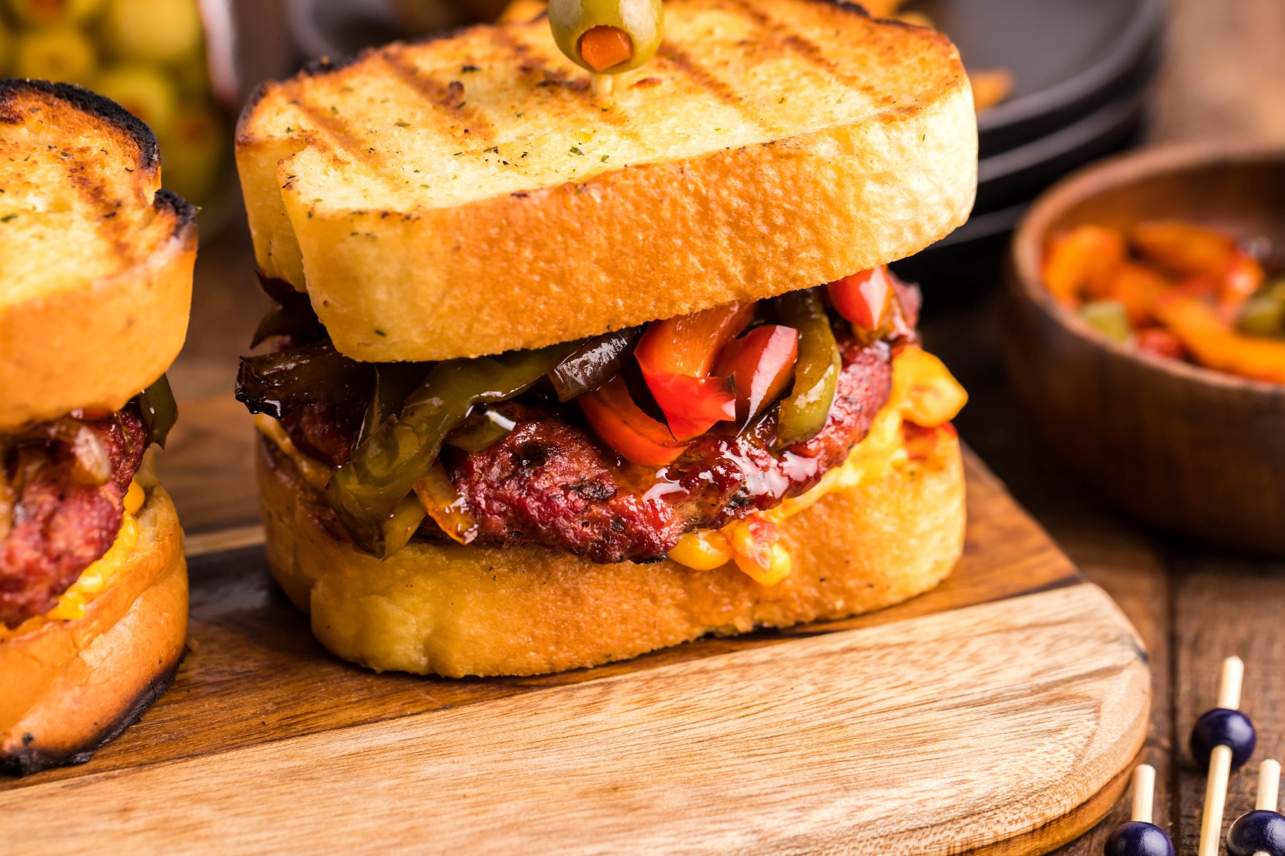 Grilled pimento patty melt sandwiches on a wooden cutting board
