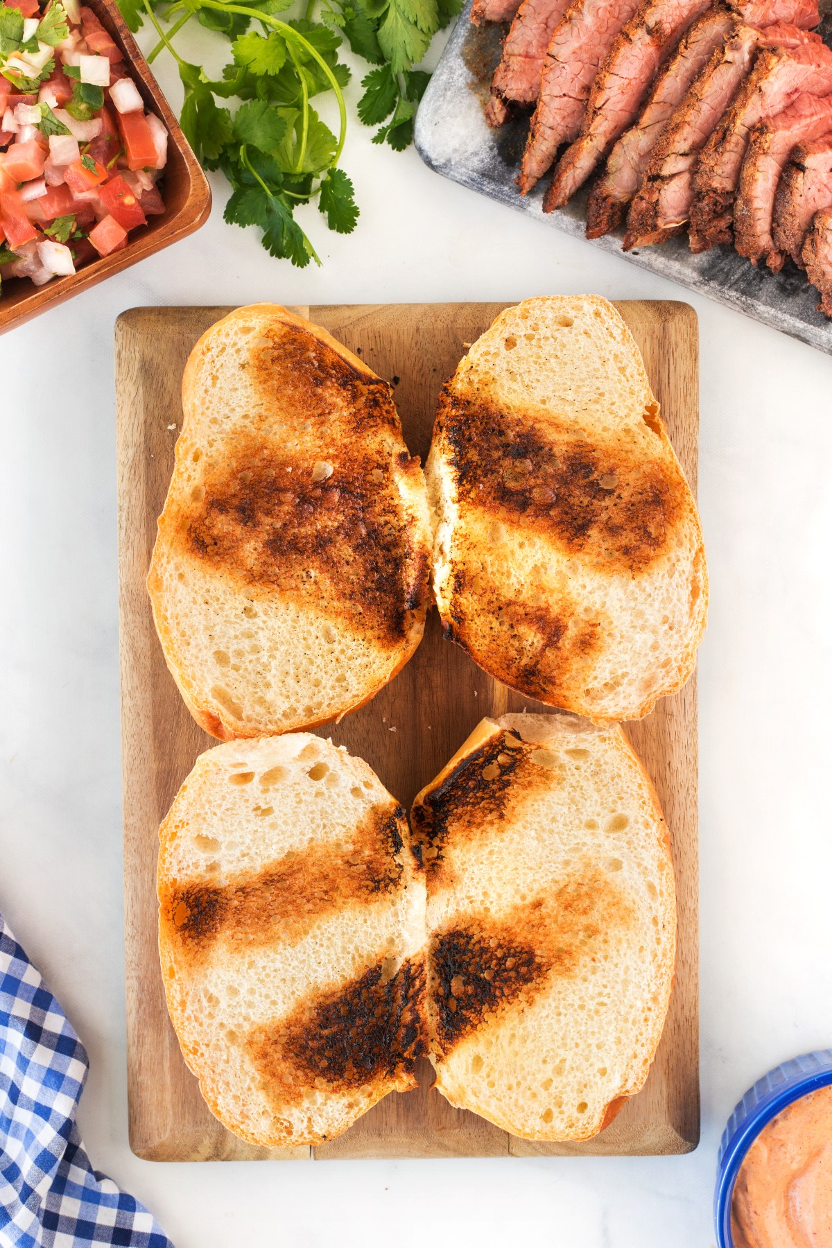 Toasted slices of bread for the grilled tri-tip steak sandwich.