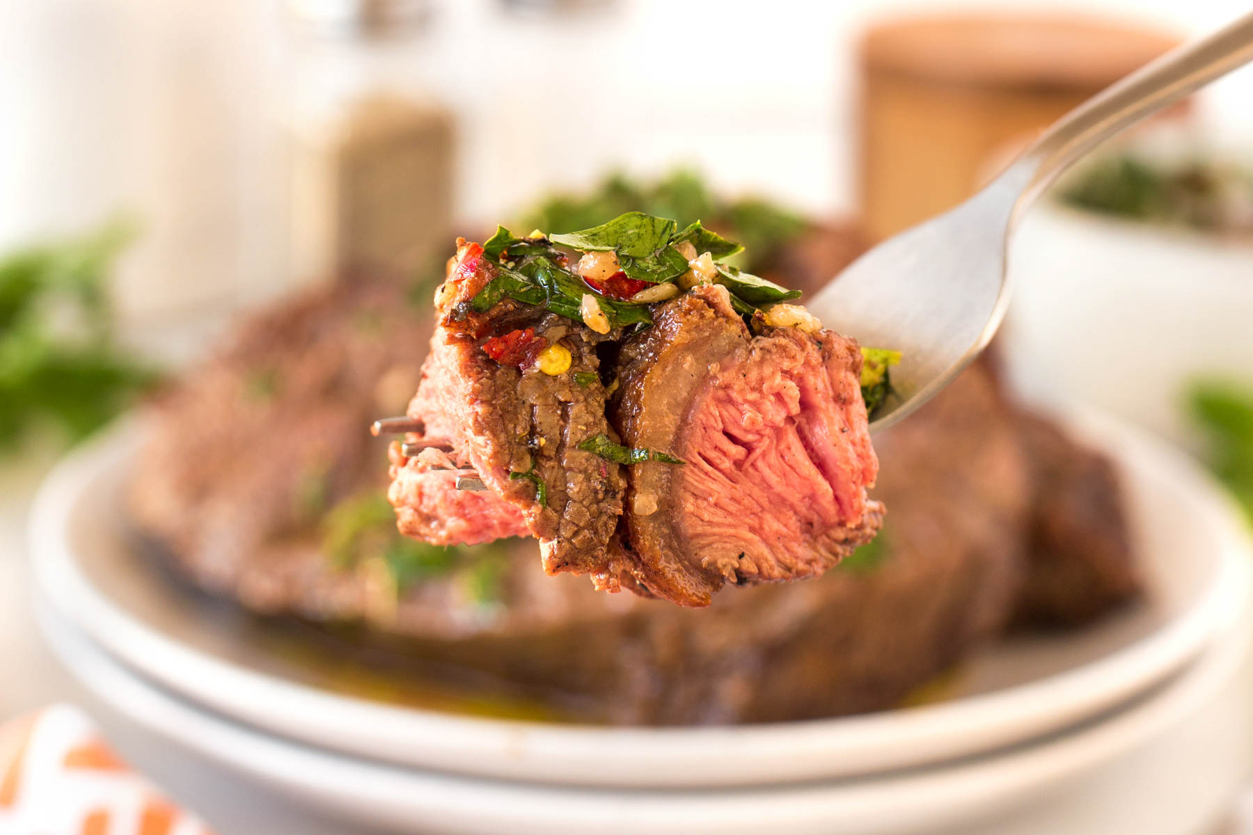 Fork full or Grilled Picanha Steak with chimichurri.