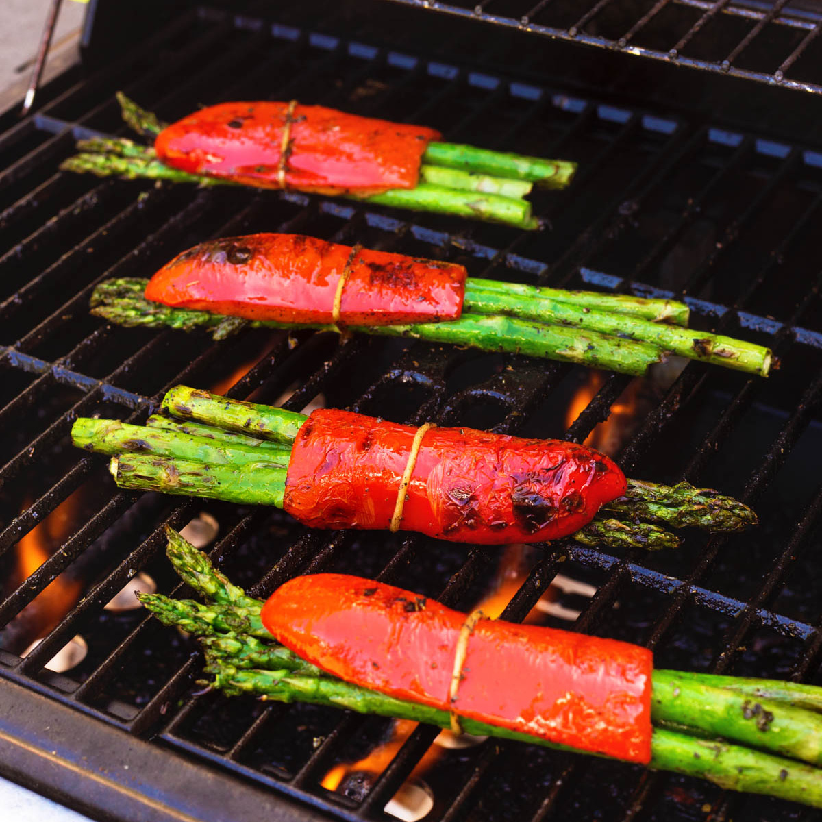 Bundles of asparagus and red pepper on the grill