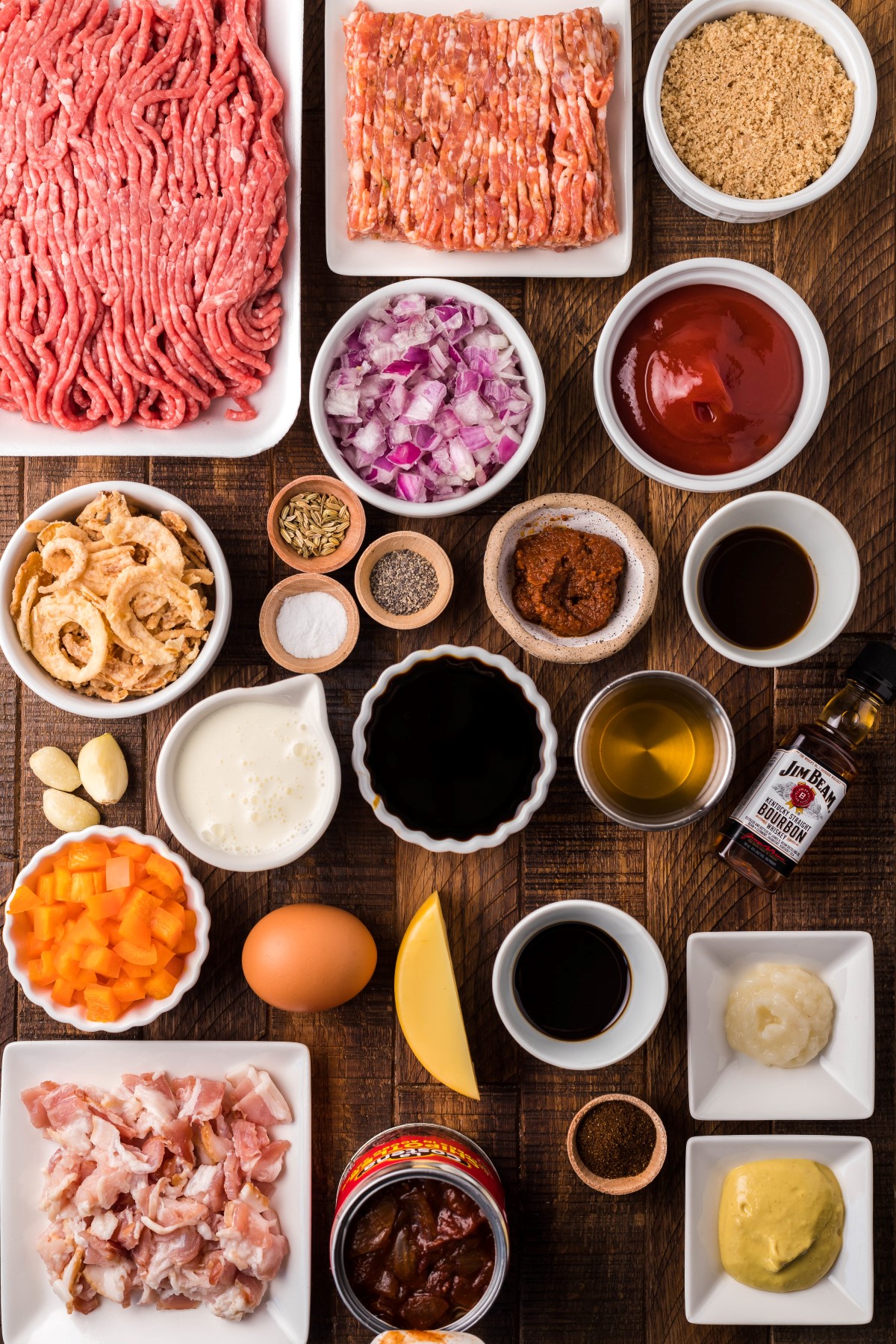 Ingredients to make smoked meatballs laid out on a wooden board.