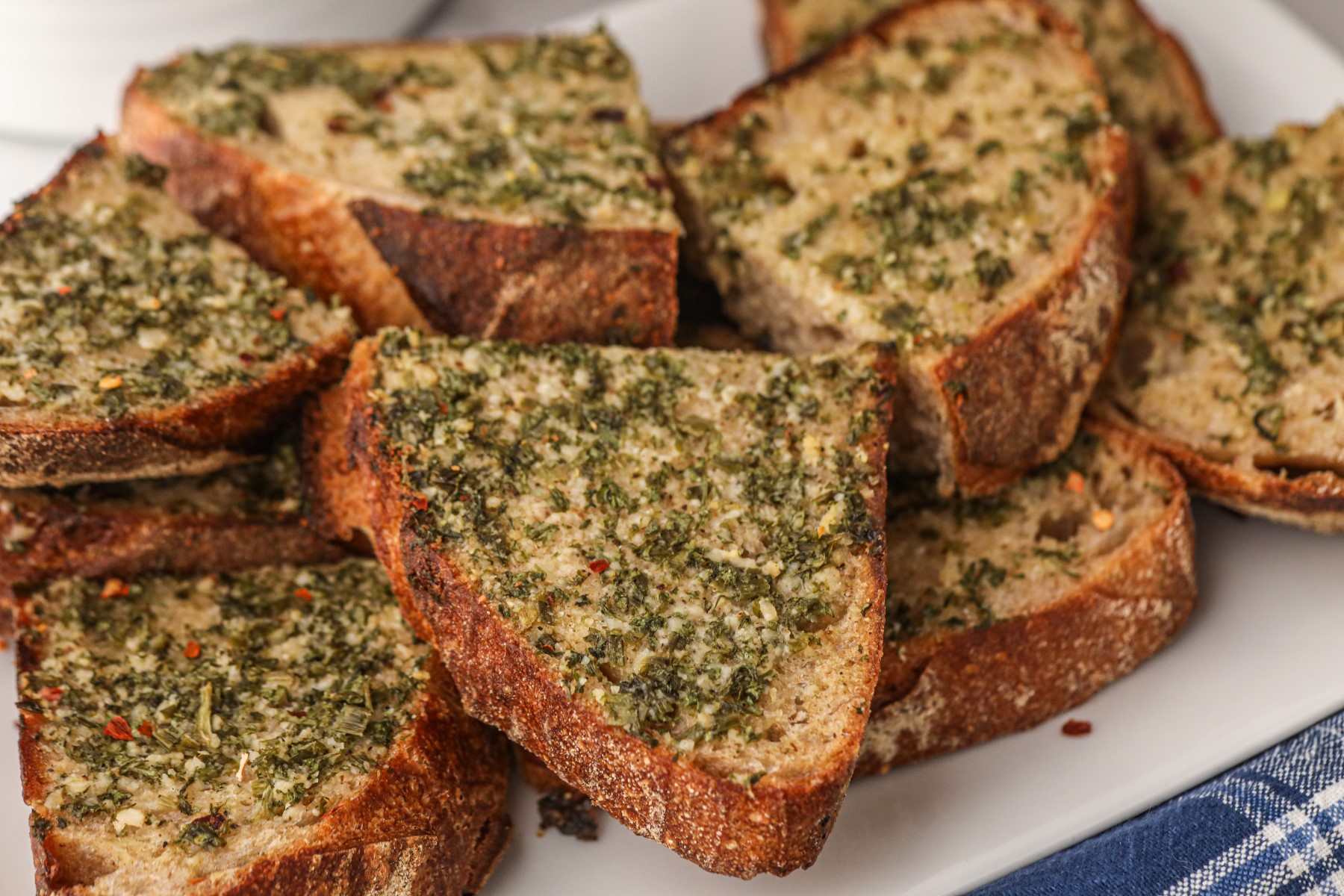 Crispy garlic bread stacked on a serving platter.