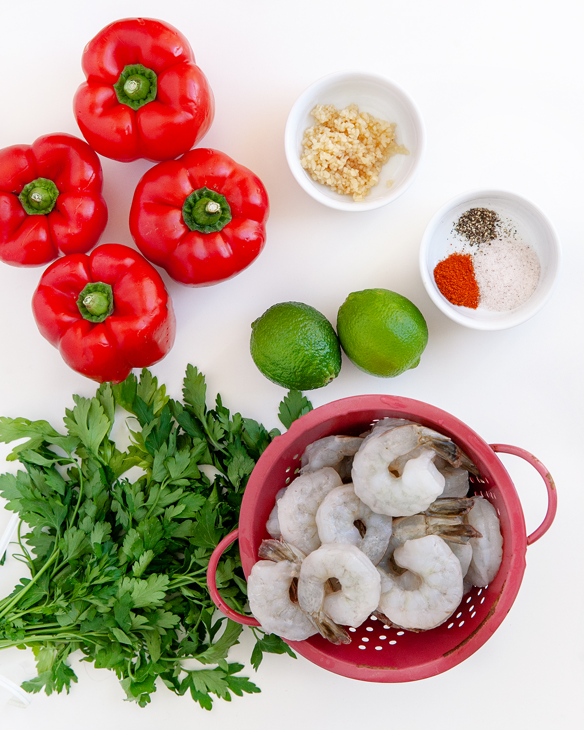Ingredients to make Grilled Shrimp Kebobs with red pepper sauce on a white countertop.