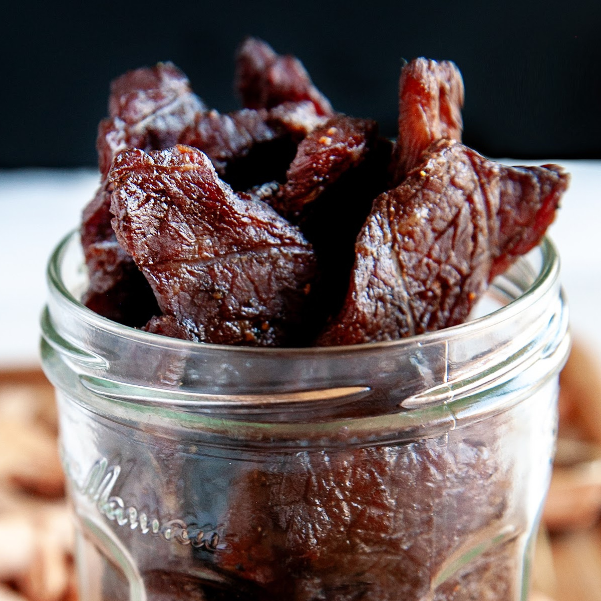 Coca-Cola smoked beef jerky standing in a glass mason jar.