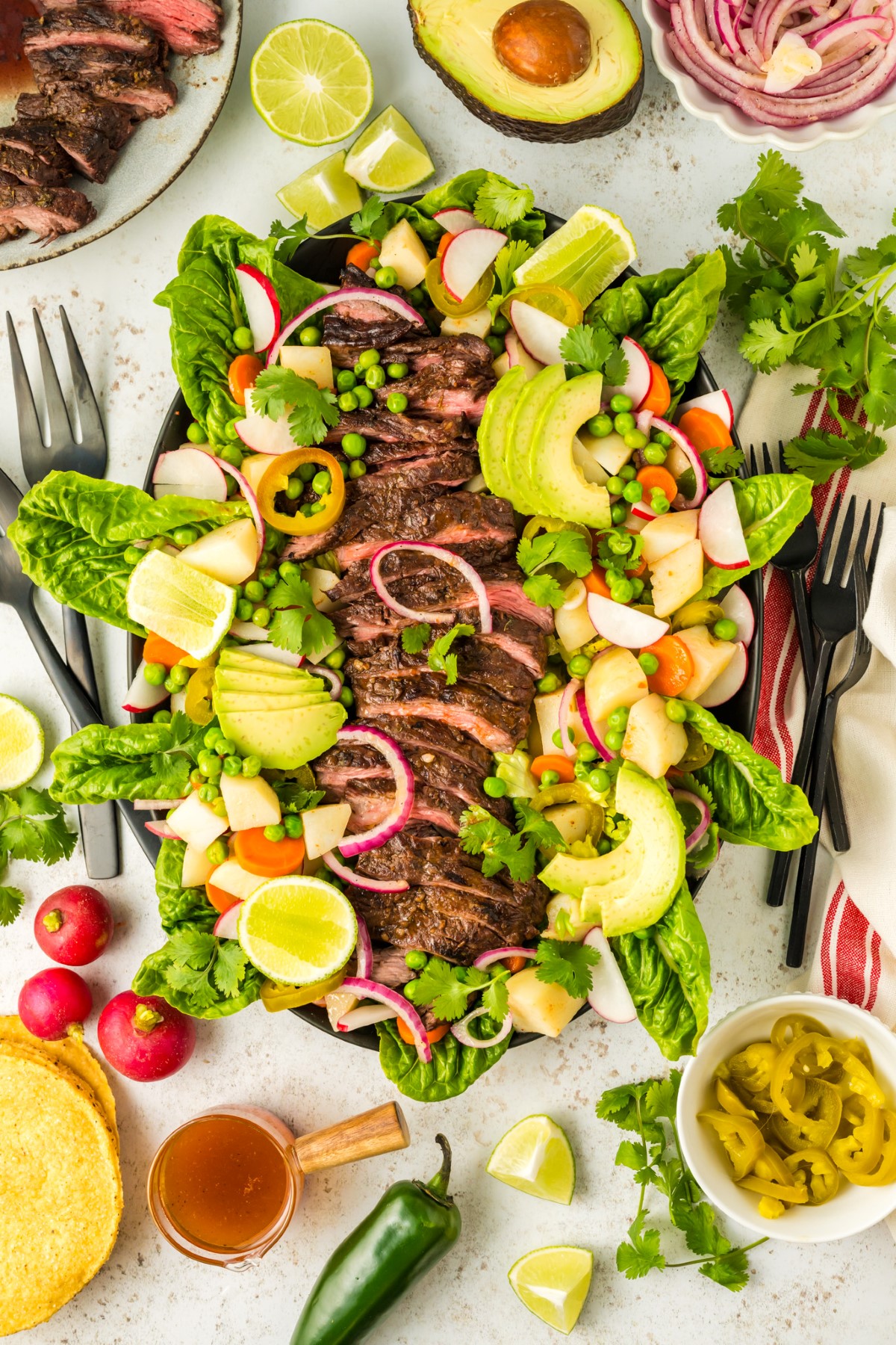 Flank steak salad prepared on a platter.